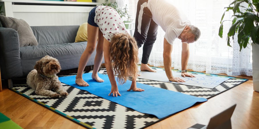 family-practicing-yoga-at-home-with-online-classes-picture-id1221031813